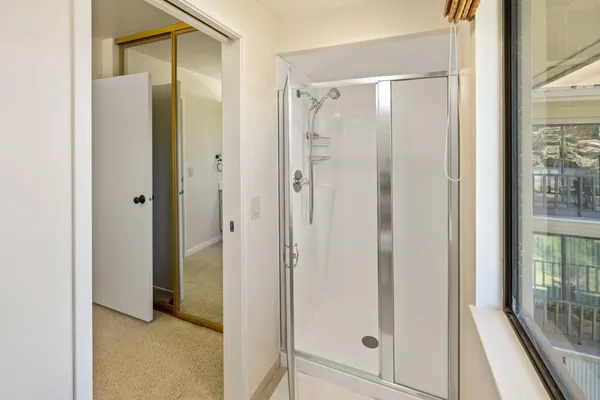 a view of bathroom with a glass shower door