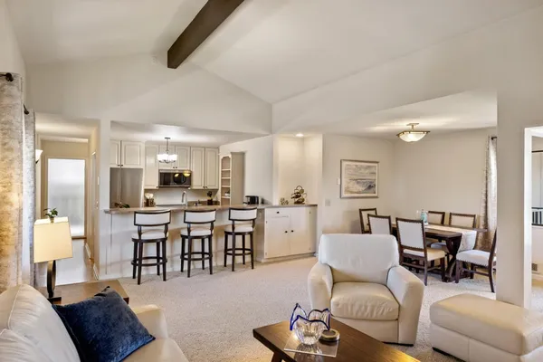 a living room with furniture a dining table and chairs