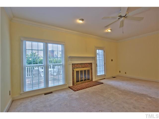 8334 Wycombe Lane Raleigh, NC 27615 - Photo 8 of 25 a view of an empty room with a fireplace and a window