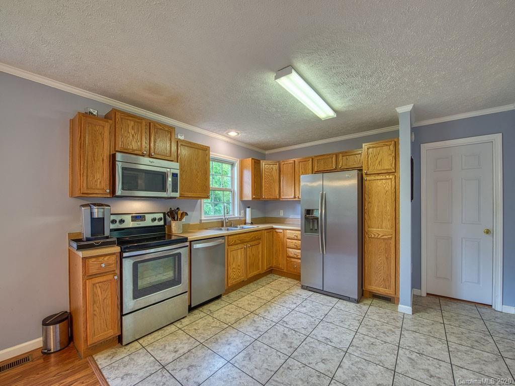 81 Relief Loop Clyde, NC 28721 - Photo 15 of 39 a kitchen with stainless steel appliances granite countertop a refrigerator a stove top oven a sink and dishwasher