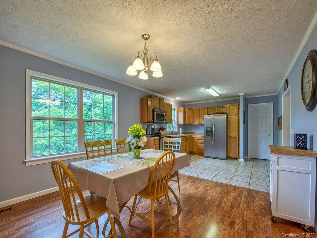 81 Relief Loop Clyde, NC 28721 - Photo 19 of 39 a view of a dining room with furniture window and wooden floor
