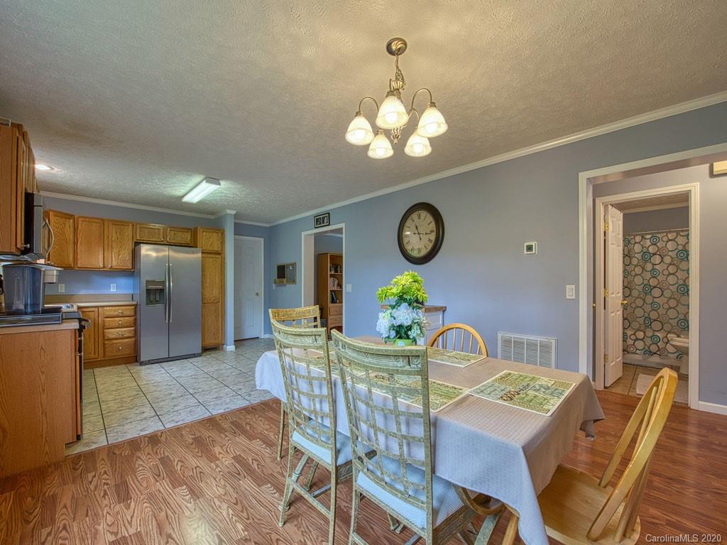 81 Relief Loop Clyde, NC 28721 - Photo 20 of 39 a view of a dining room with furniture a chandelier and wooden floor