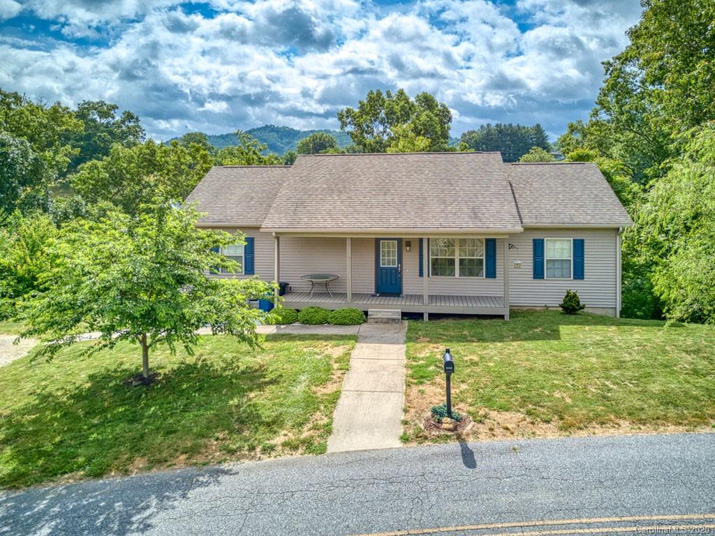 81 Relief Loop Clyde, NC 28721 - Photo 3 of 39 a front view of a house with a garden