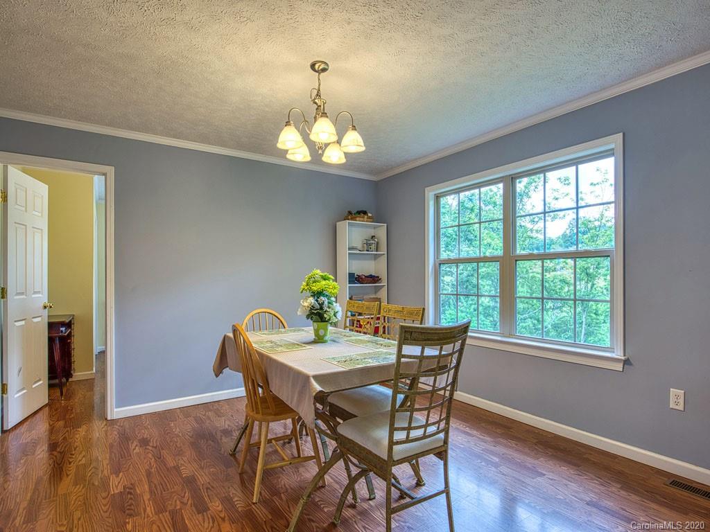 81 Relief Loop Clyde, NC 28721 - Photo 21 of 39 a view of a dining room with furniture a chandelier and wooden floor