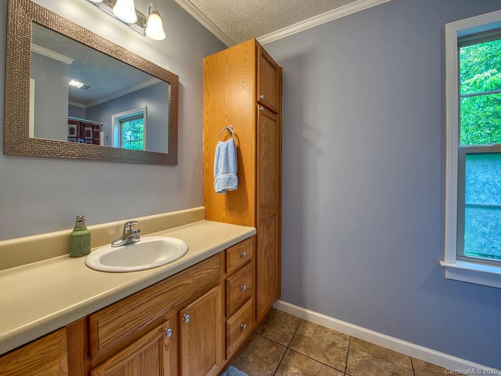 81 Relief Loop Clyde, NC 28721 - Photo 25 of 39 a bathroom with a sink and a mirror