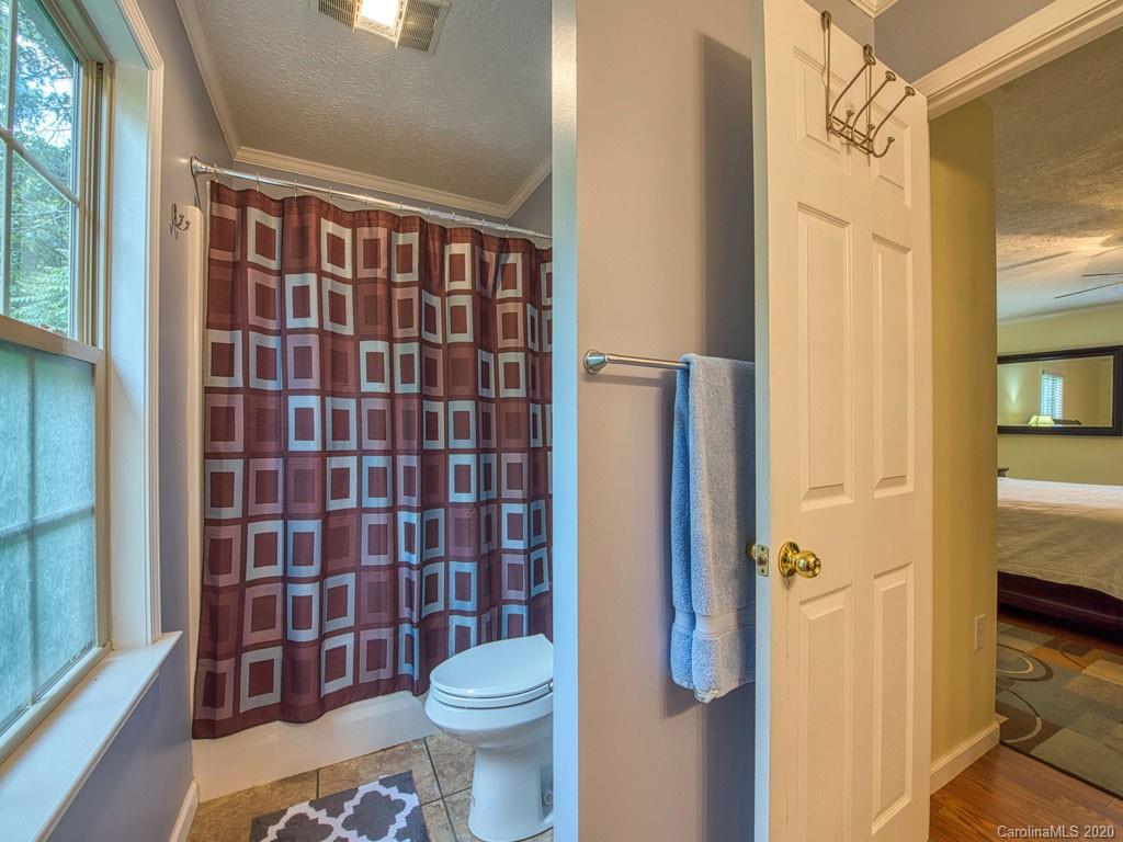 81 Relief Loop Clyde, NC 28721 - Photo 26 of 39 a bathroom with a toilet and a shower