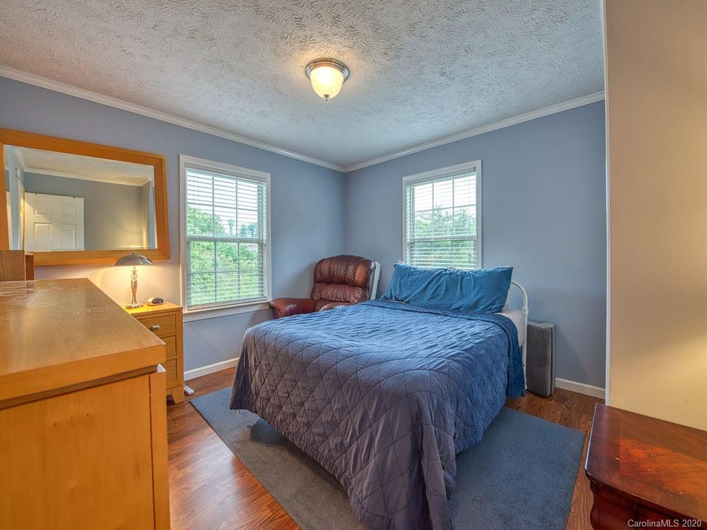 81 Relief Loop Clyde, NC 28721 - Photo 27 of 39 a bedroom with a bed and window