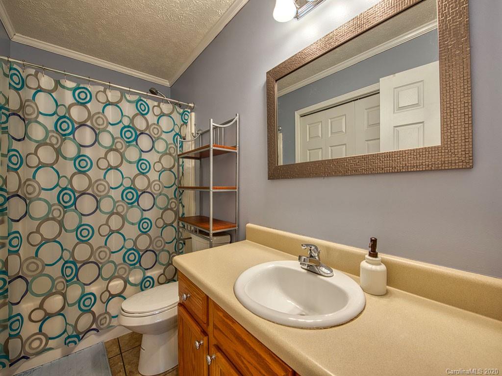 81 Relief Loop Clyde, NC 28721 - Photo 30 of 39 a bathroom with a sink and a mirror