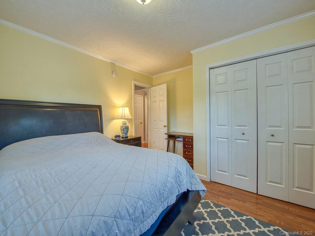 81 Relief Loop Clyde, NC 28721 - Photo 33 of 39 a bedroom with a bed and wooden floor