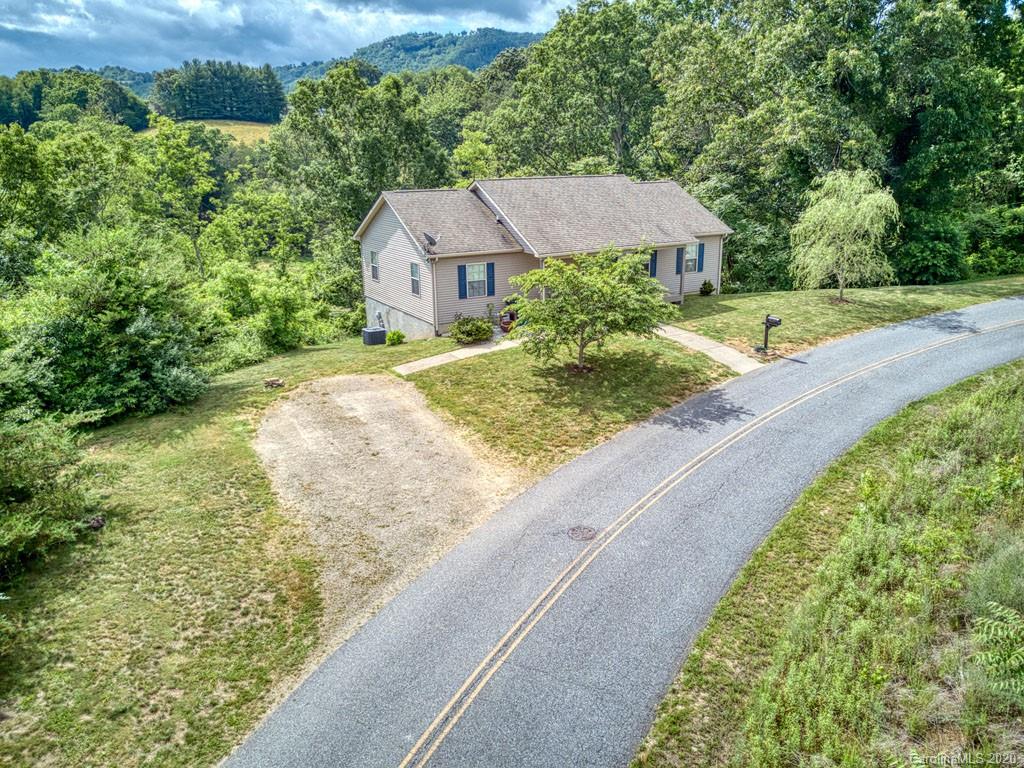 81 Relief Loop Clyde, NC 28721 - Photo 5 of 39 a aerial view of a house with a yard and potted plants