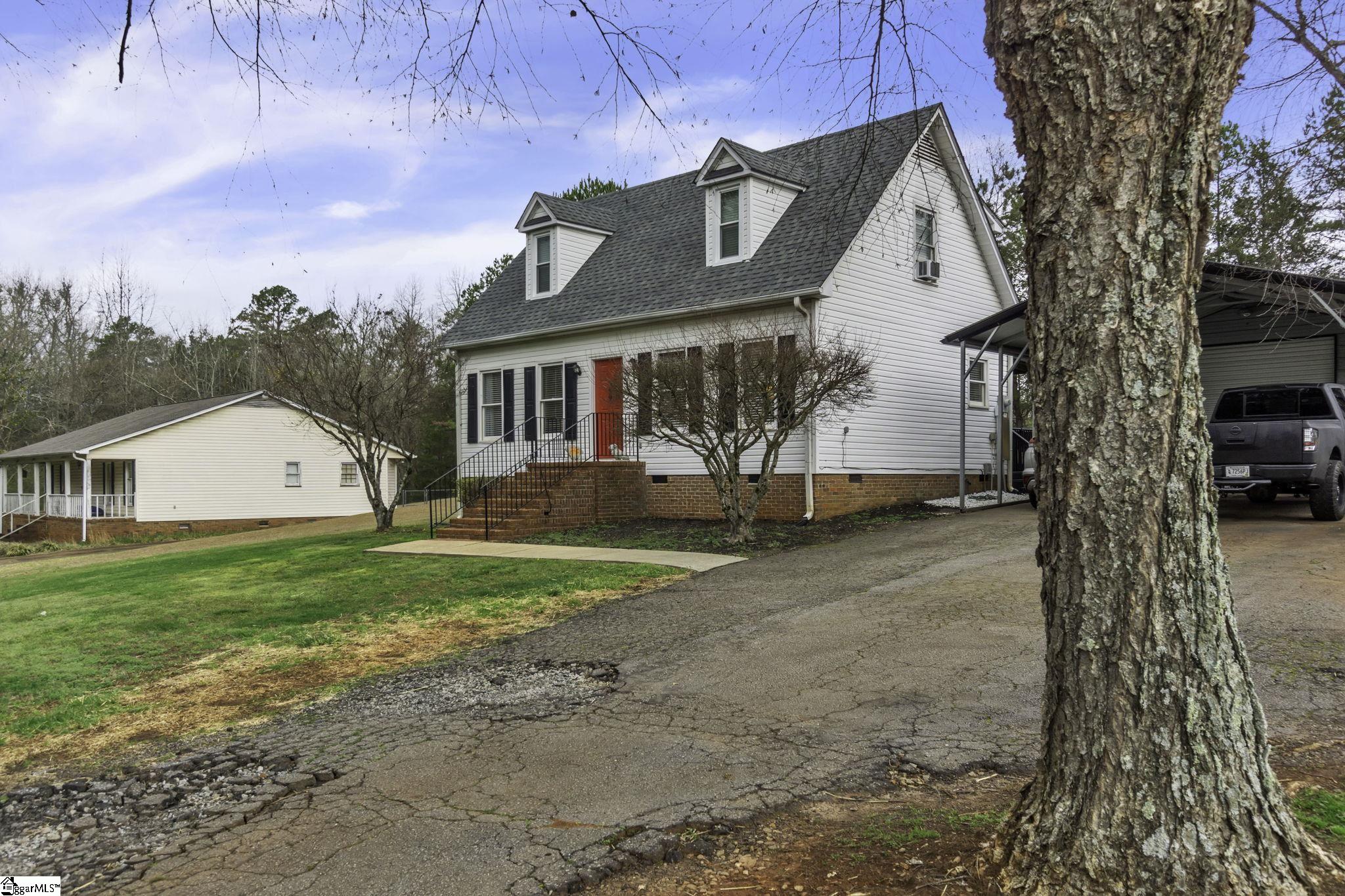 599 Sheriff Mill Road Easley, SC 29642 - Photo 2 of 29 Paved driveway plus two car detached carport and one car detached garage. Great for workshop as well.