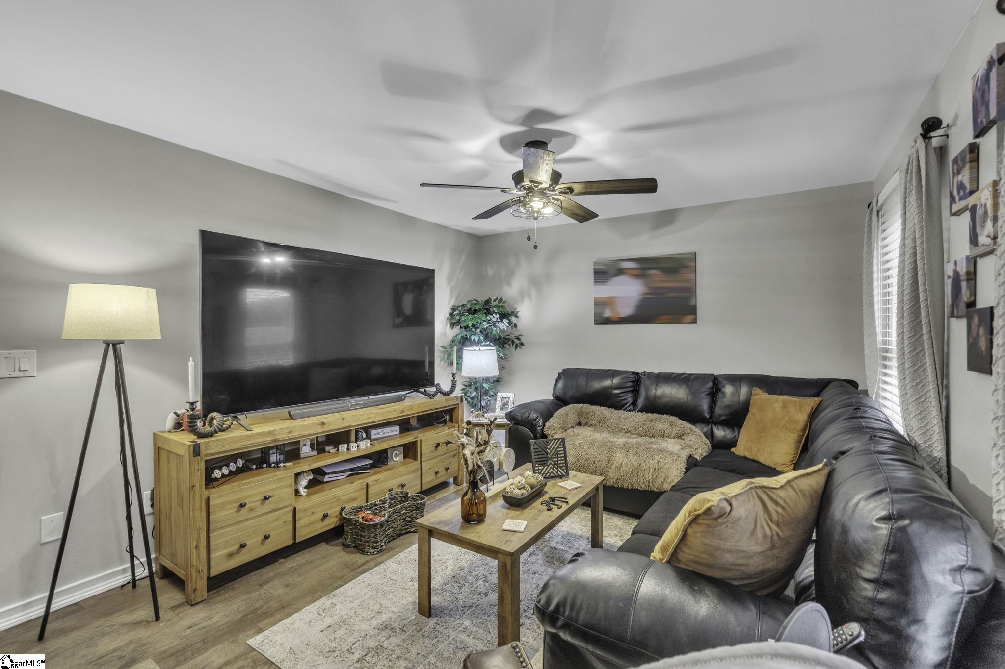 599 Sheriff Mill Road Easley, SC 29642 - Photo 4 of 29 Living Room is neutral colors and laminate flooring plus ceiling fan.