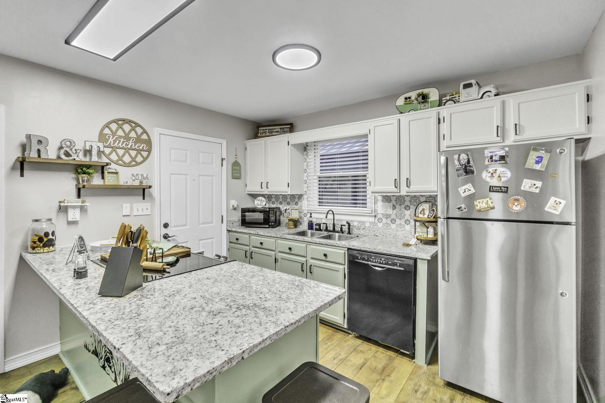 599 Sheriff Mill Road Easley, SC 29642 - Photo 6 of 29 Large granite counter work area, window of sink, and open to Dining Area.