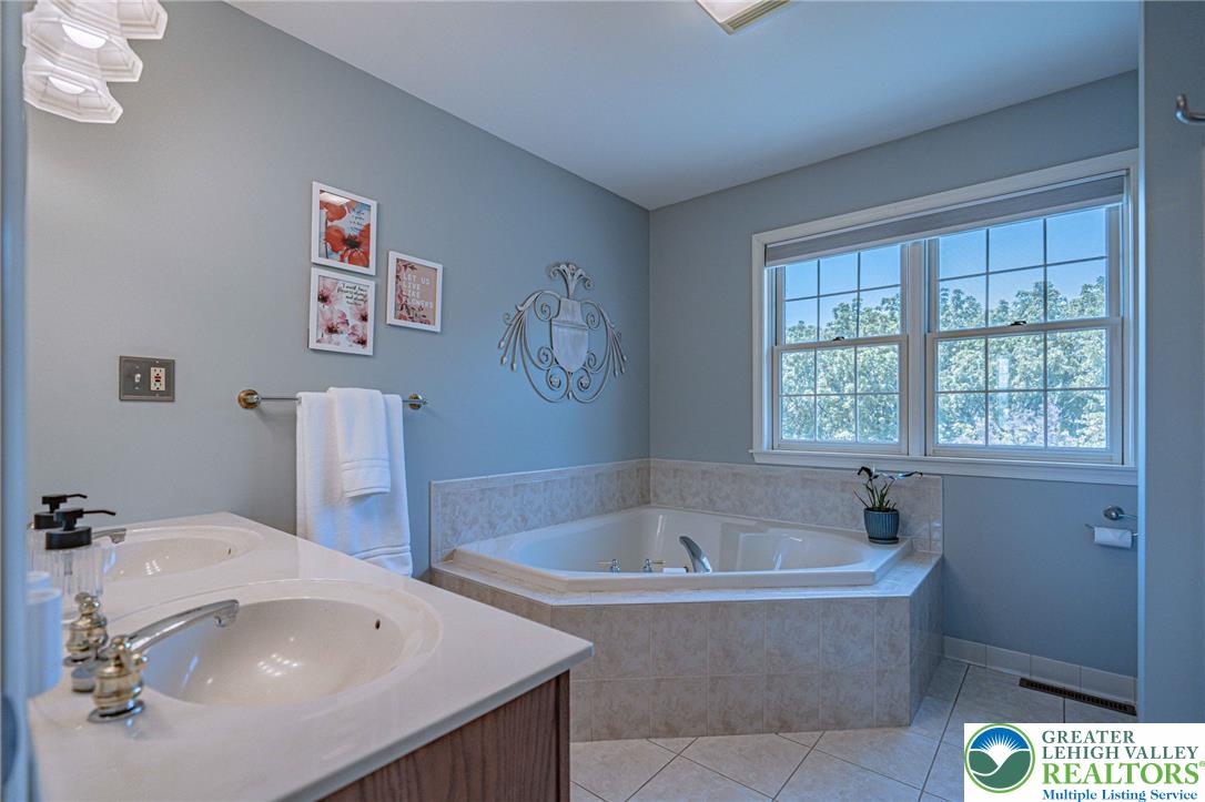4542 Springfield Drive Coplay, PA 18037 - Photo 42 of 89 Double vanity and a deep soaking tub create a personal spa retreat.