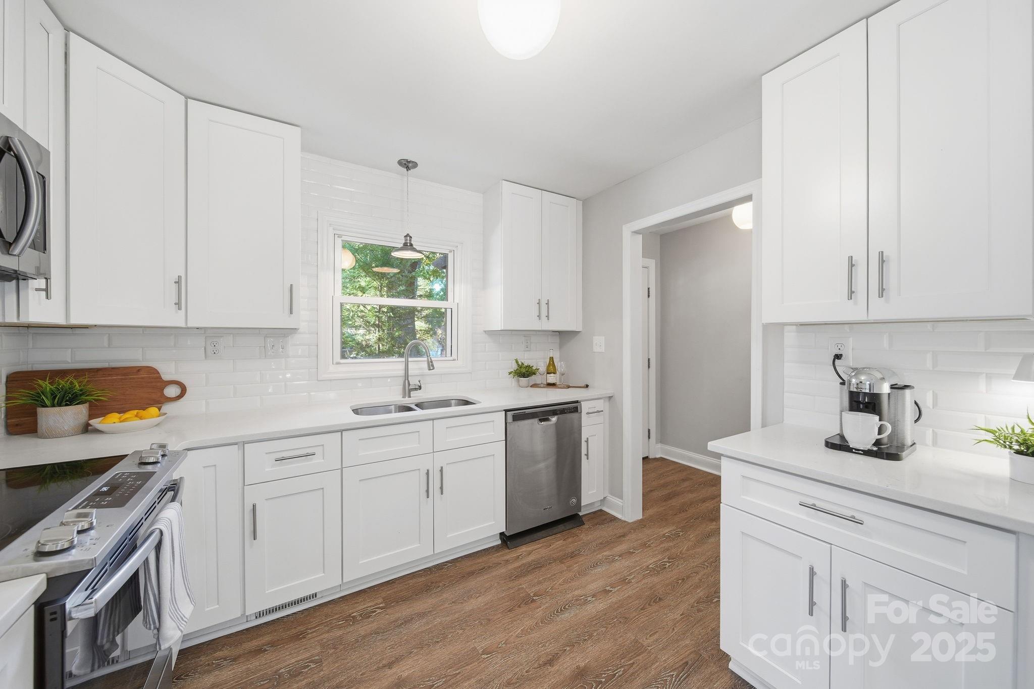 5631 Londonderry Road Charlotte, NC 28210 - Photo 11 of 32 a kitchen with sink cabinets and wooden floor