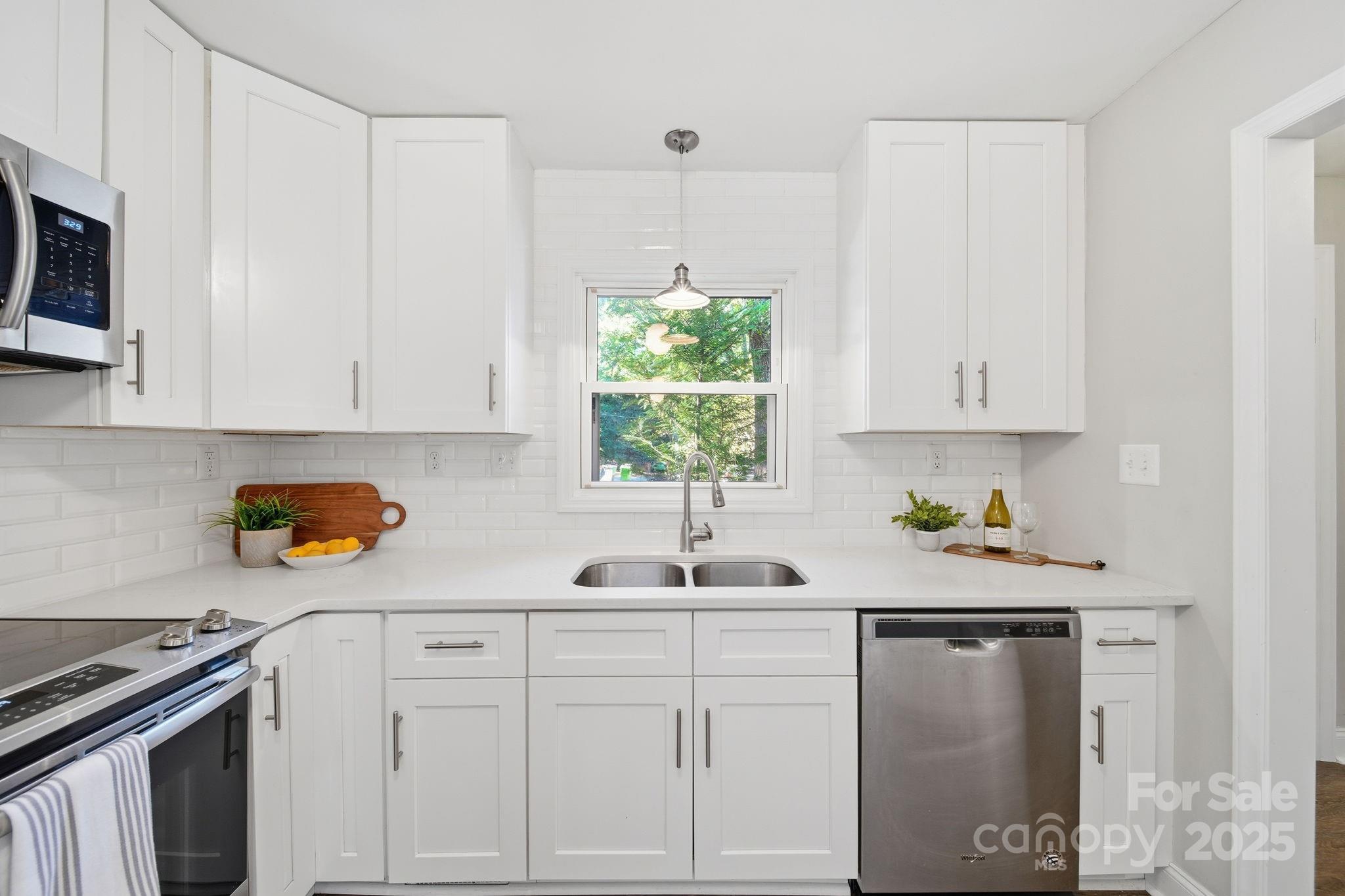 5631 Londonderry Road Charlotte, NC 28210 - Photo 12 of 32 a kitchen with white cabinets and appliances