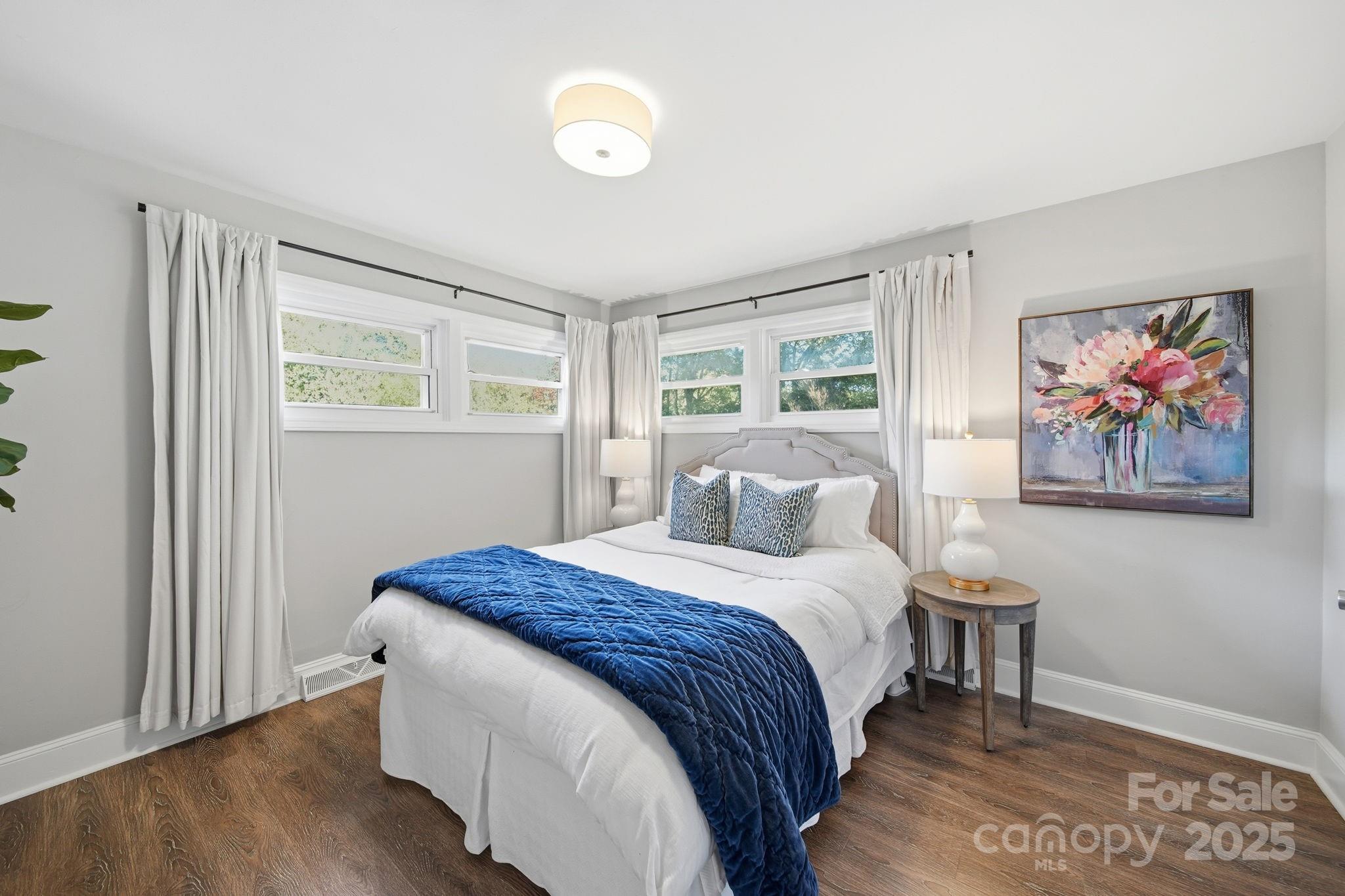 5631 Londonderry Road Charlotte, NC 28210 - Photo 16 of 32 a bedroom with a bed and a painting on the wall