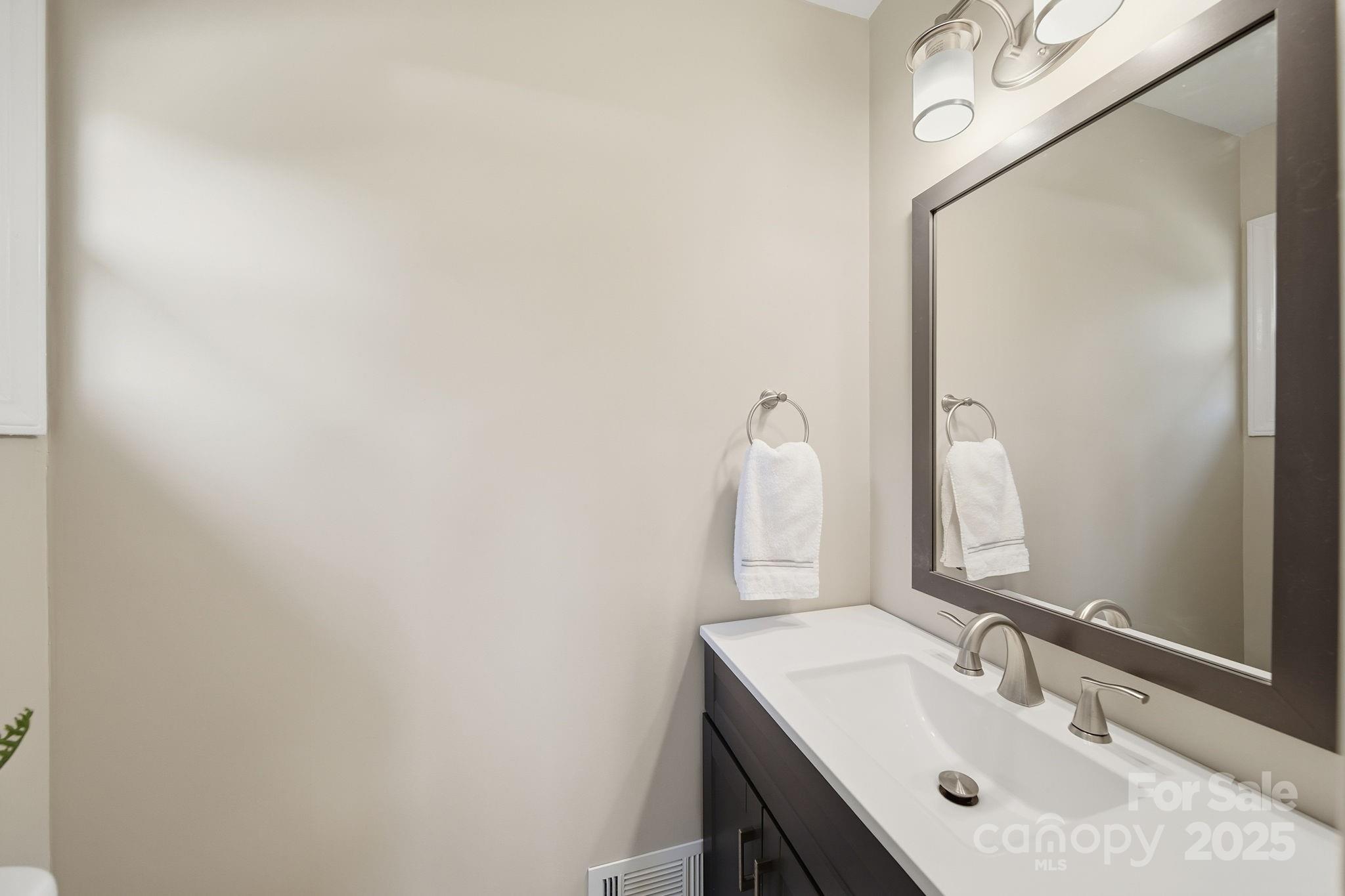 5631 Londonderry Road Charlotte, NC 28210 - Photo 18 of 32 a bathroom with a sink and a mirror