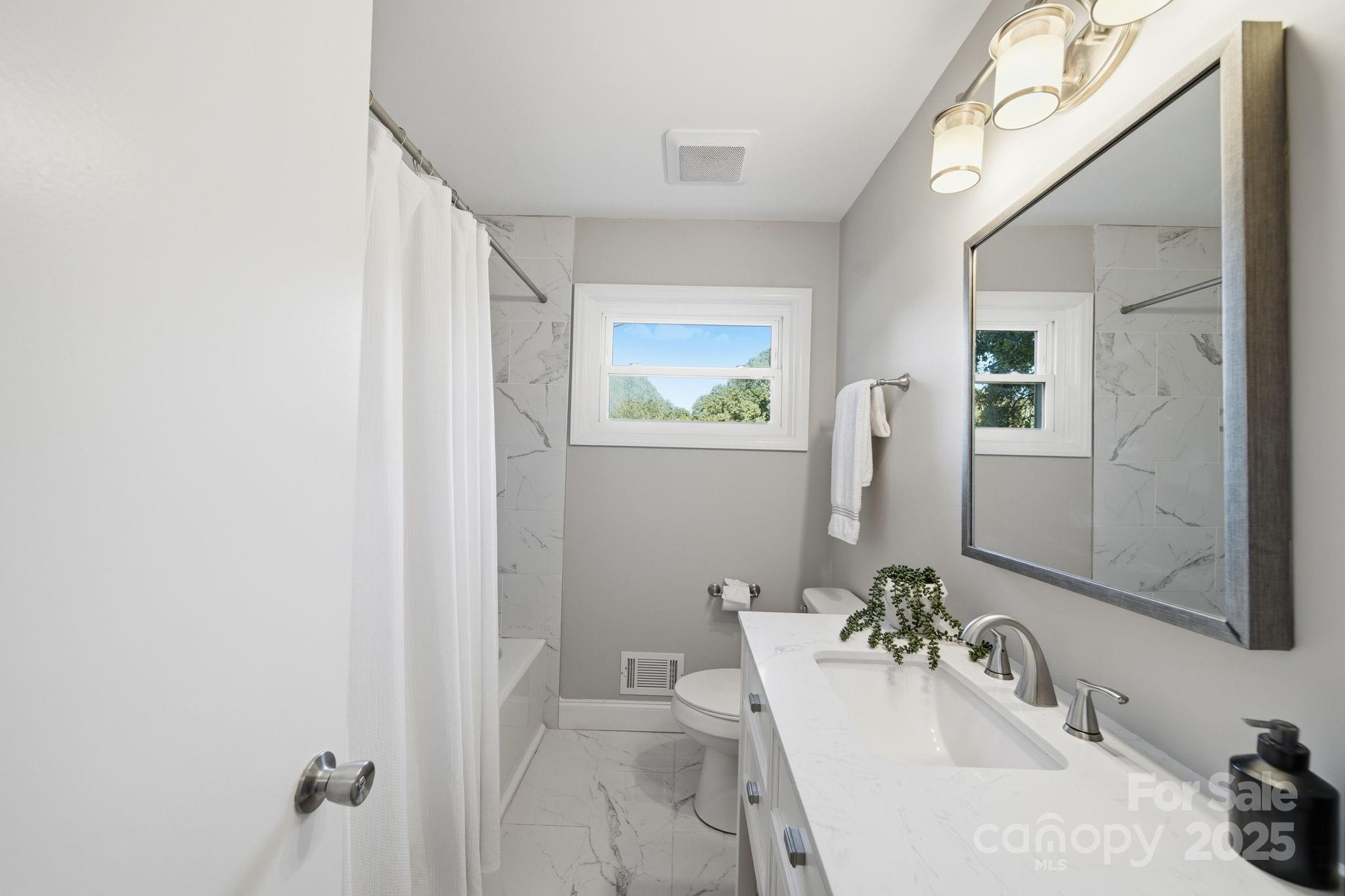 5631 Londonderry Road Charlotte, NC 28210 - Photo 21 of 32 a bathroom with a sink and a mirror