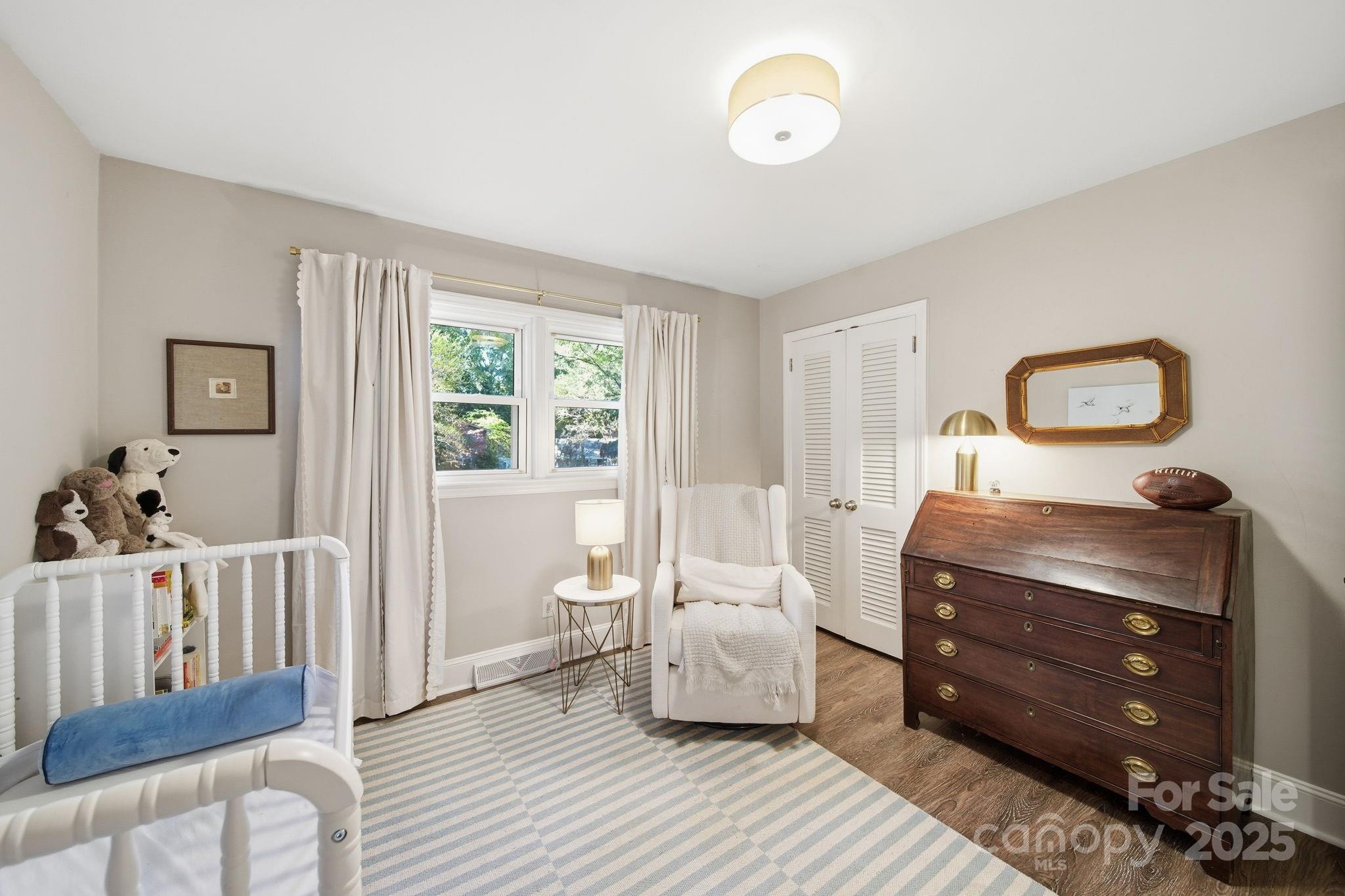 5631 Londonderry Road Charlotte, NC 28210 - Photo 24 of 32 a bedroom with a bed and wooden floor