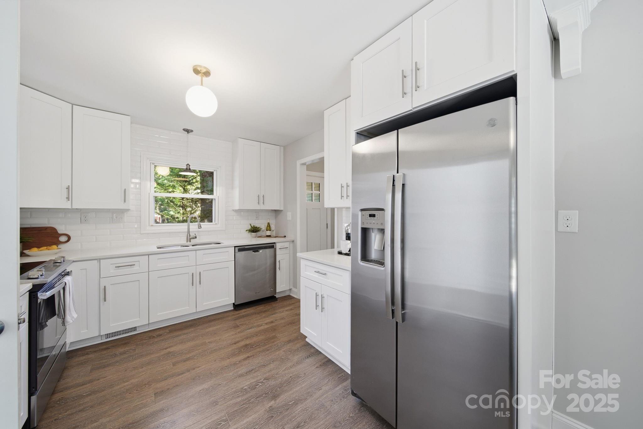 5631 Londonderry Road Charlotte, NC 28210 - Photo 10 of 32 a kitchen with white cabinets and white appliances