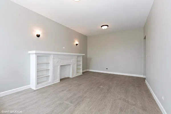a view of an empty room with a closet and a window