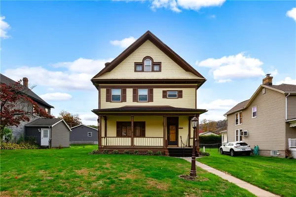 a front view of a house with a yard
