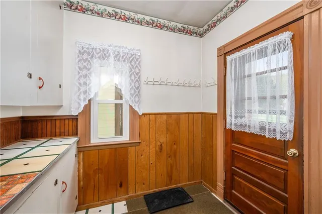a view of walk in closet with window and shower