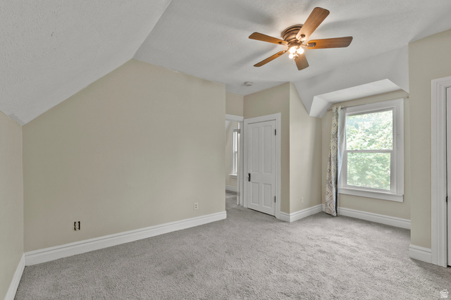 148 South 300 East Logan, UT 84321 - Photo 14 of 29 Carpeted room featuring a ceiling fan, white trim, and a window with a tree-lined exterior