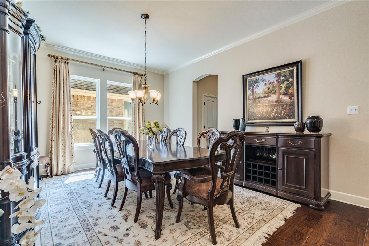12909 Medina River Way Austin, TX 78732 - Photo 9 of 36 Elegant crown molding complements the hardwood flooring in this formal dining area.