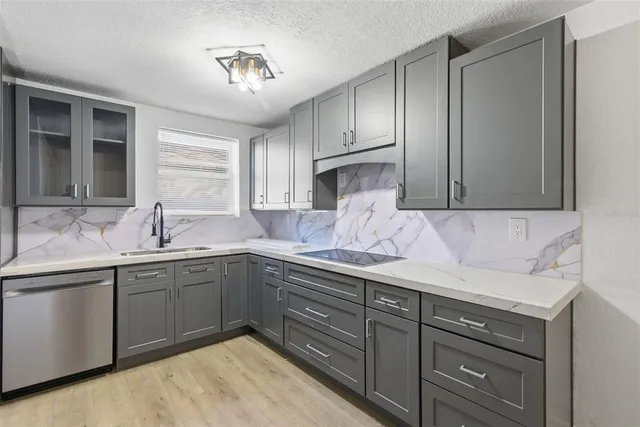 a kitchen with kitchen island a sink stainless steel appliances and cabinets