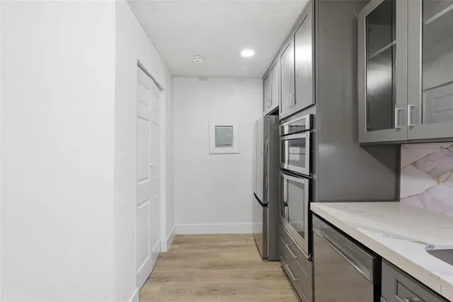 a view of a room with wooden floor and white walls