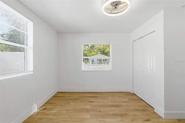 a view of a room with wooden floor