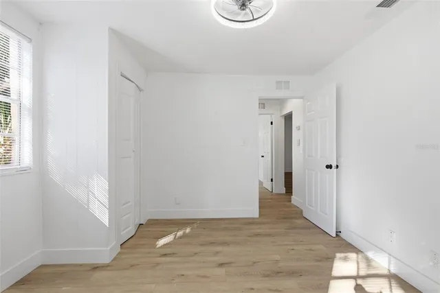 a view of a house with backyard and trees