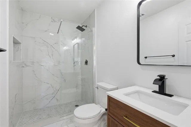 a kitchen with white cabinets and a window