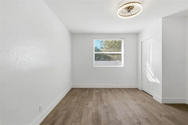 a view of a room with wooden floor