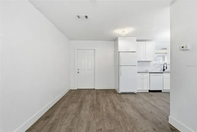 a view of a livingroom with wooden floor and closet area