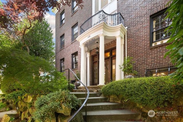 a view of a building with a tree in front