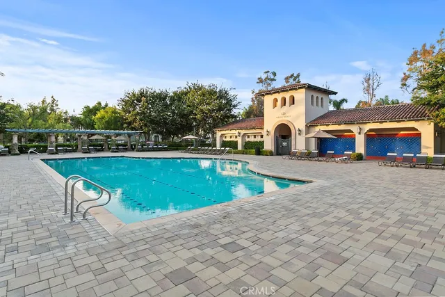 a view of a white house with a swimming pool and a yard