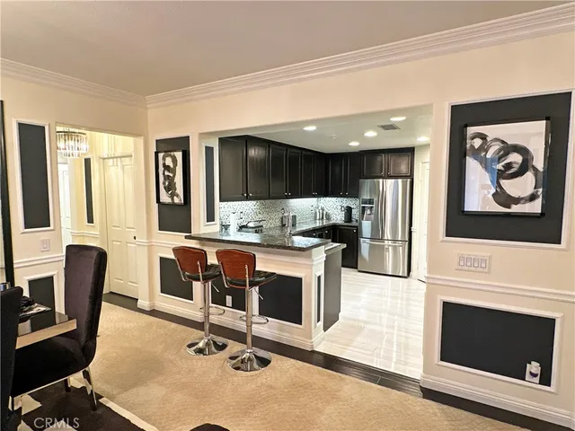 a view of kitchen with granite countertop cabinets table and chairs
