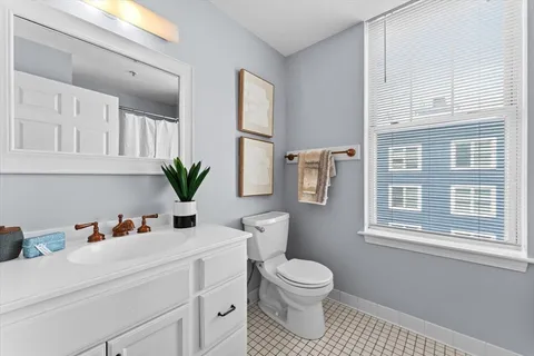 a bathroom with a toilet sink and mirror