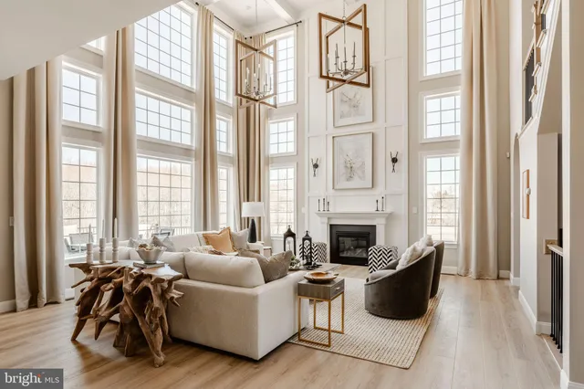 a spacious bedroom with a bed and a chandelier