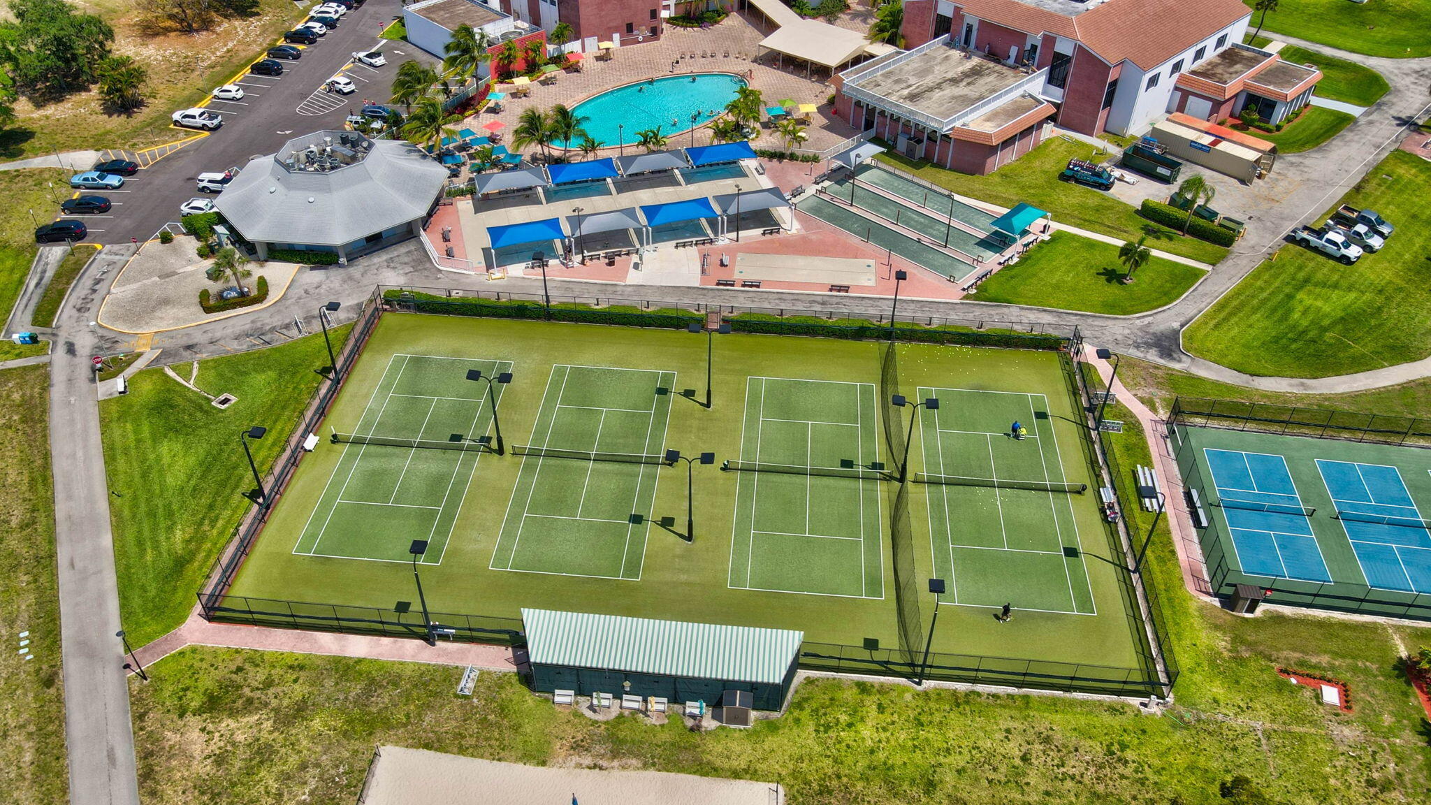 326 Farnham O, Unit P Deerfield Beach, FL 33442 - Photo 76 of 86 an aerial view of a tennis ground with large trees