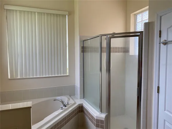 a bathroom with a bathtub and a shower