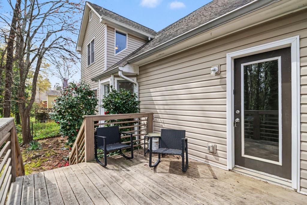 3793 Market Crescent Clarkston, GA 30021 - Photo 32 of 35 a view of a patio with table and chairs and wooden floor