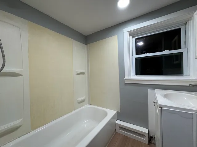 a bathroom with a bathtub and a sink