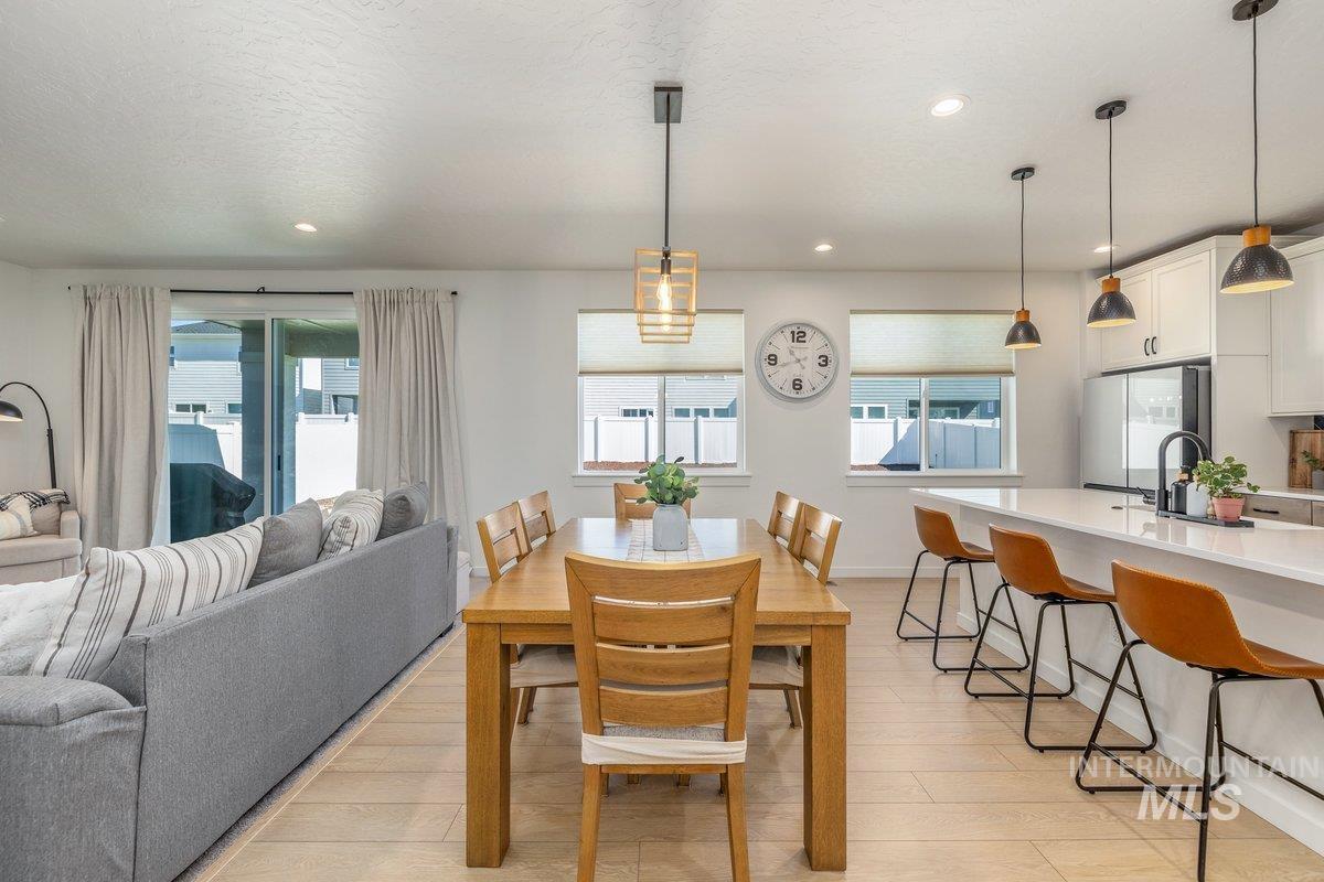 1380 West Chilitna Street Meridian, ID 83642 - Photo 19 of 50 Open-concept living area featuring wood-finish flooring, recessed lighting, and a sliding glass door