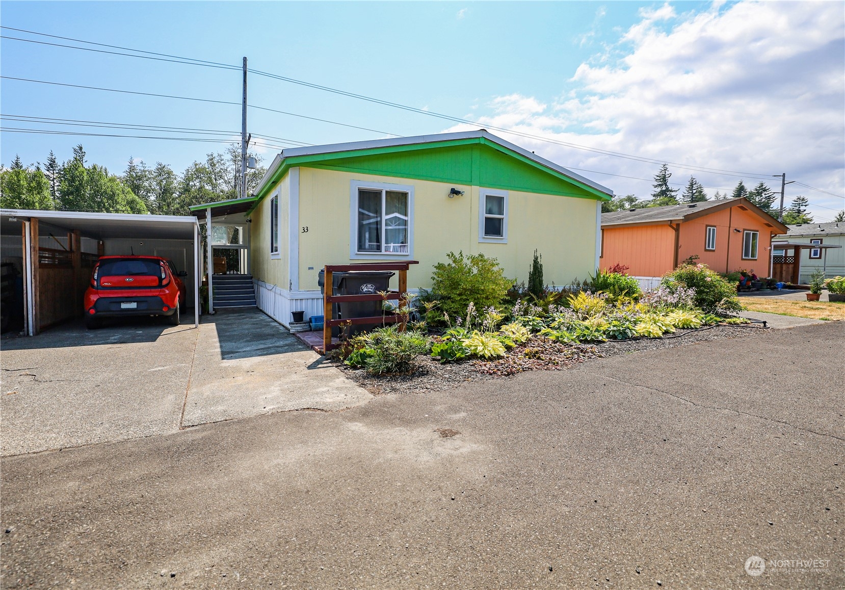 9 Poplar Road, Unit 33 Montesano, WA 98563 - Photo 1 of 18 a front view of a house with a yard and a garage
