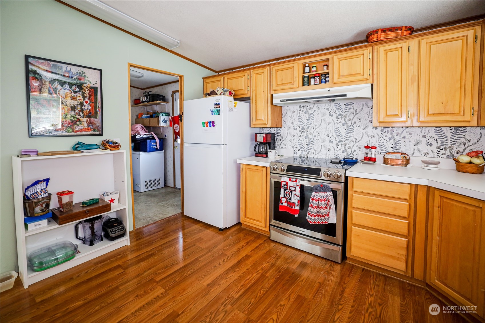 9 Poplar Road, Unit 33 Montesano, WA 98563 - Photo 5 of 18 a kitchen with stainless steel appliances granite countertop a stove and wooden floor