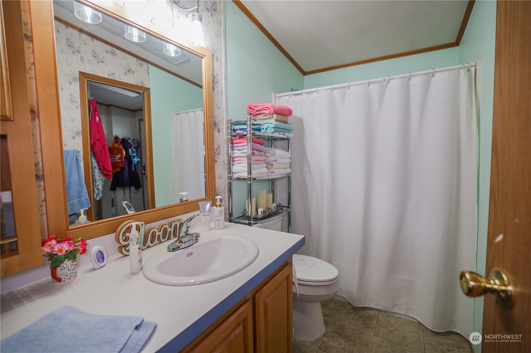 9 Poplar Road, Unit 33 Montesano, WA 98563 - Photo 10 of 18 a bathroom with a sink vanity mirror and toilet